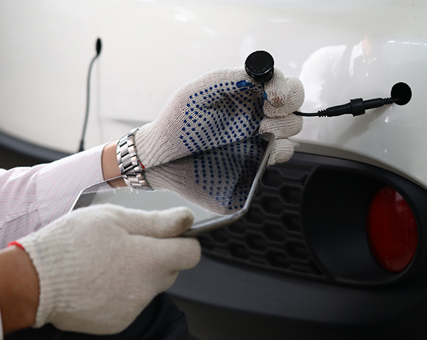 parking sensors being fitted to a car